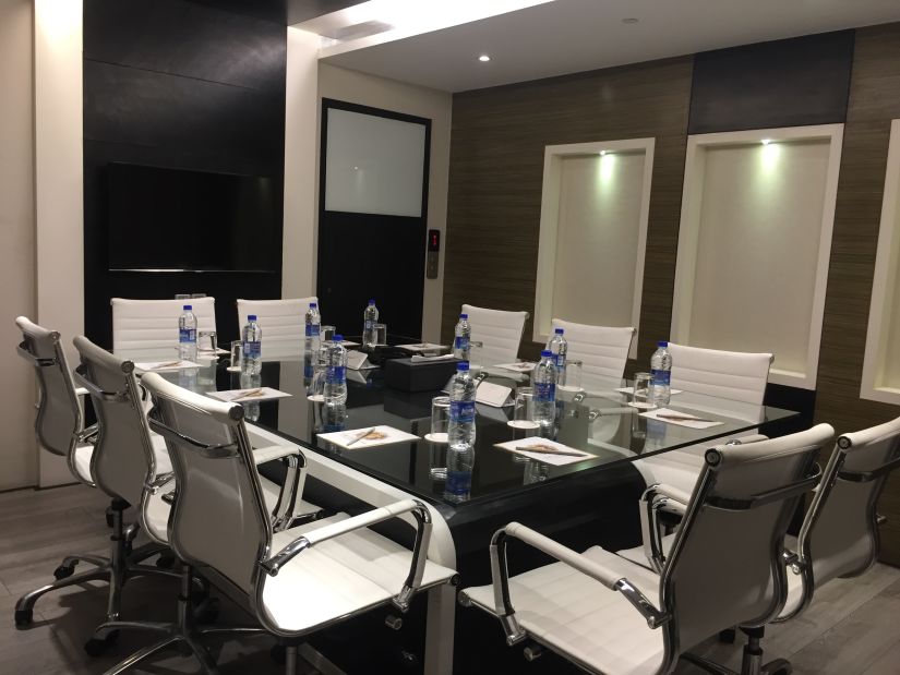 a conference hall with chairs and a table 