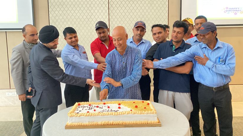 a team cutting a cake