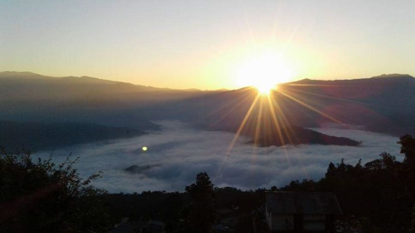 a panoramic view of the hills with the sun rising behind the hills