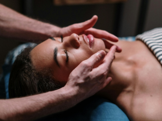 Close-up of a facial massage focusing on the jawline, inducing relaxation.