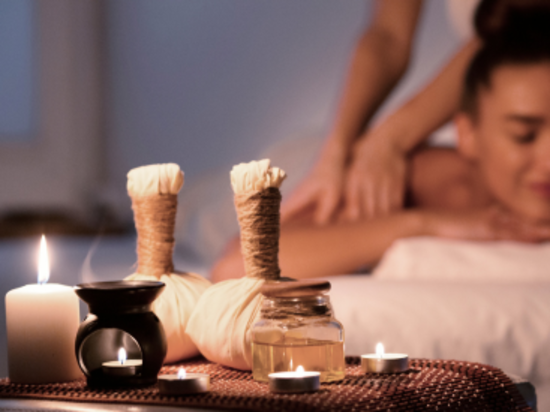 A woman enjoying a calming  massage in a spa.