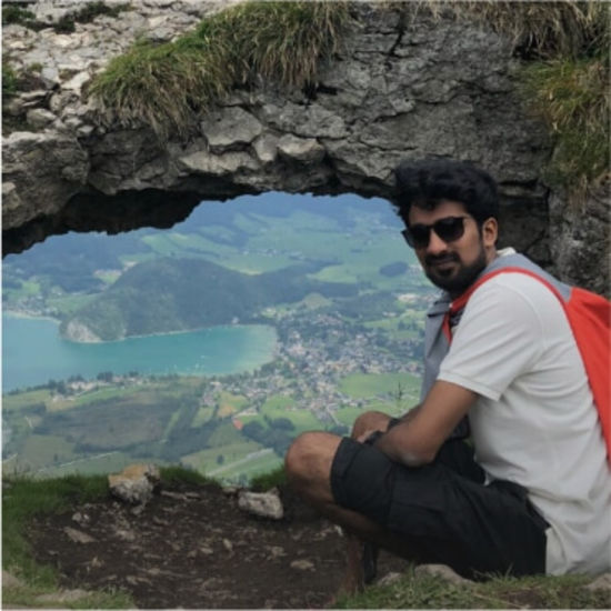 Photo of Vasu with a rock formation in the background