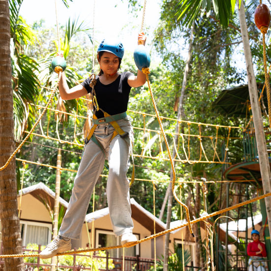 A person having fun on a zip line activity - Stone Wood Nature Resort, Gokarna