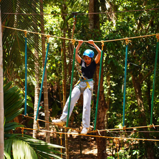 A participant engaging in an adventure activity while wearing safety gear and a harness - Stone Wood Nature Resort, Gokarna