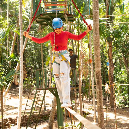 A person balancing on a slack line - Stone Wood Nature Resort, Gokarna