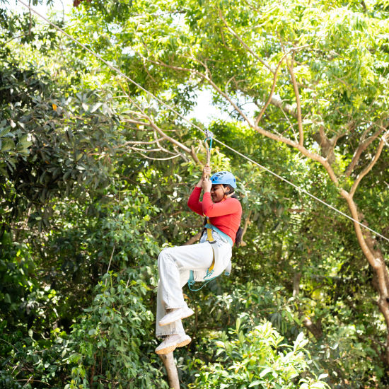 A person enjoying a zip line activity - Stone Wood Nature Resort, Gokarna