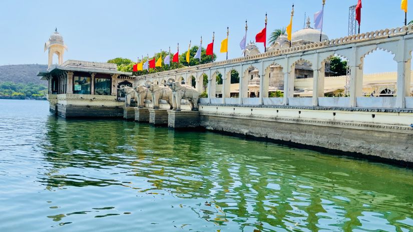 Pier with colorful flags by the lake - Jag Mandir