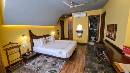 A bedroom at Ekaa Villa & Kitchen with a double bed and seating arrangement - 2