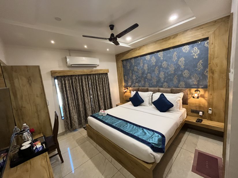 Side view of the Deluxe room with a cosy king-sized bed at Clarks Collection, Somnath