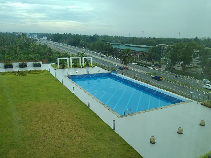 O by Tamara, Trivandrum - an aerial view of the lawn and the pool in Trivandrum