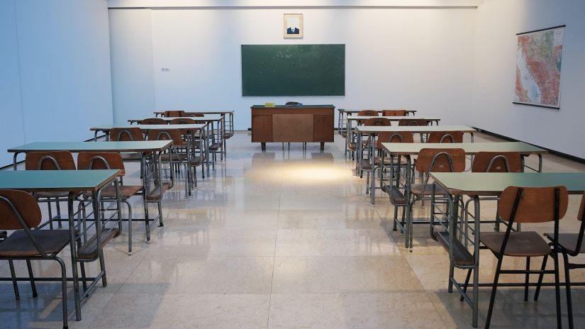 an empty classroom with chairs and desks leading to a board