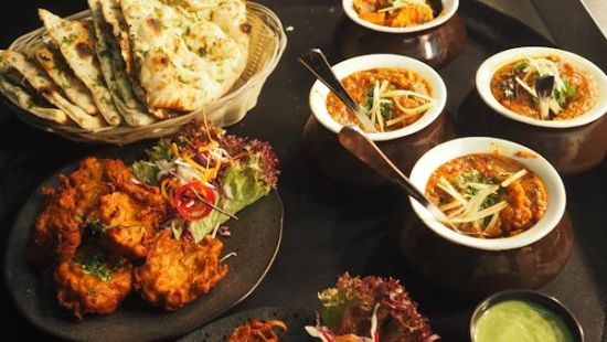 Image of an assortment of Indian dishes neately placed on a table