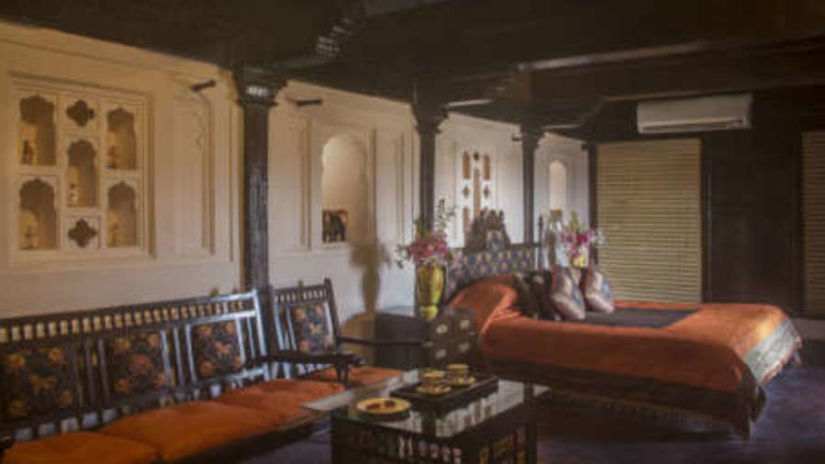 an image showing a rajasthani bed and interior decoration of a room - Fort Jadhavgarh Pune