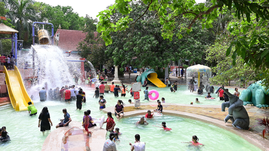 Water Kingdom - A group of people enjoying in a pool at our water park during daytime