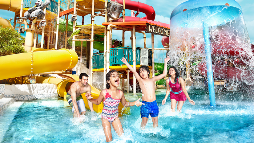 Water Kingdom - a family of 4 playing in a pool at our water park in Mumbai