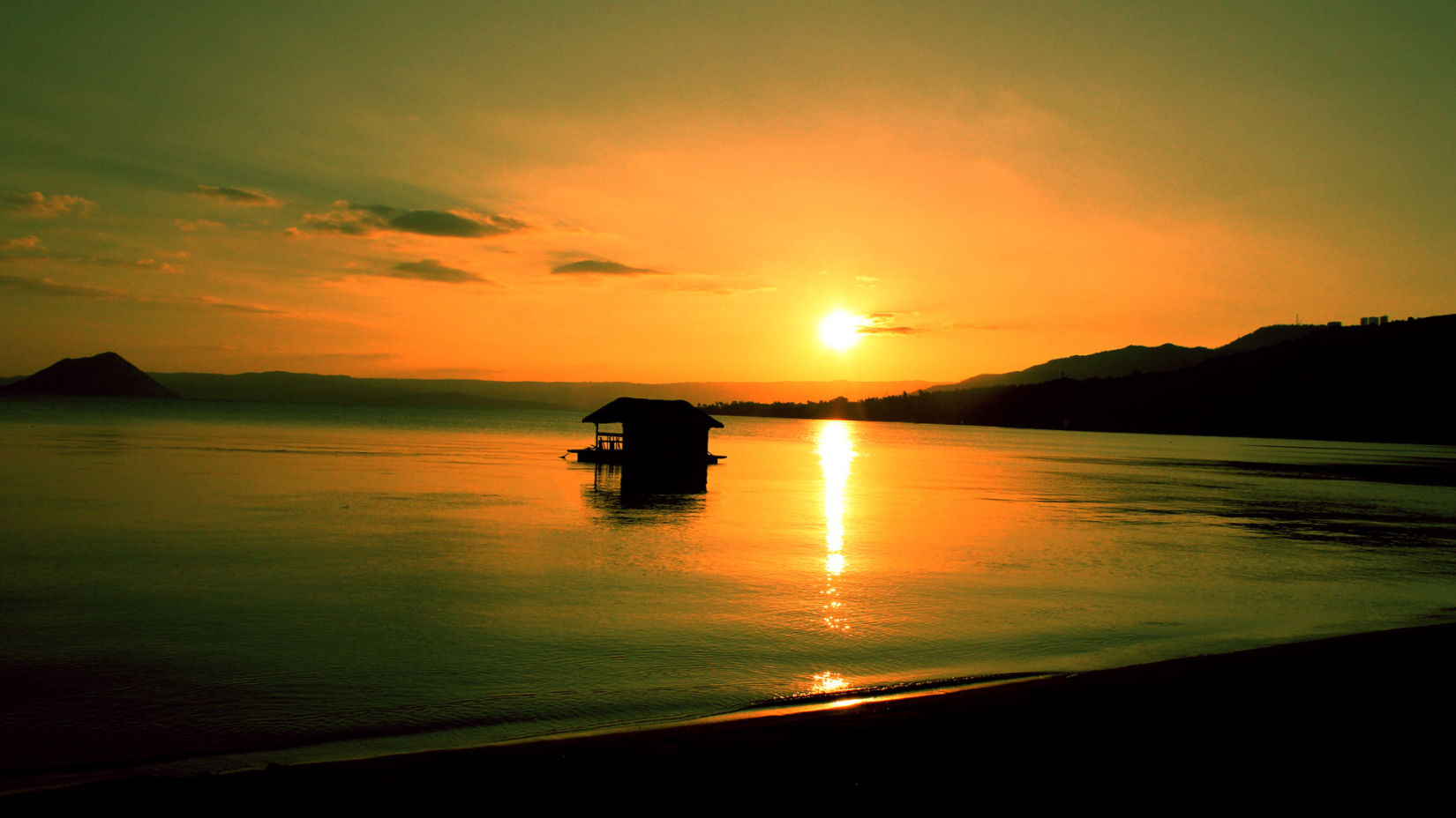  A serene sunset over a calm lake, with the sun's reflection on the water and a solitary boat creating a tranquil silhouette against the golden sky.