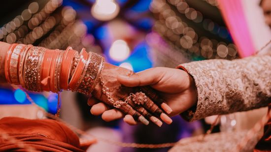 a close up shot of a couple holding hands