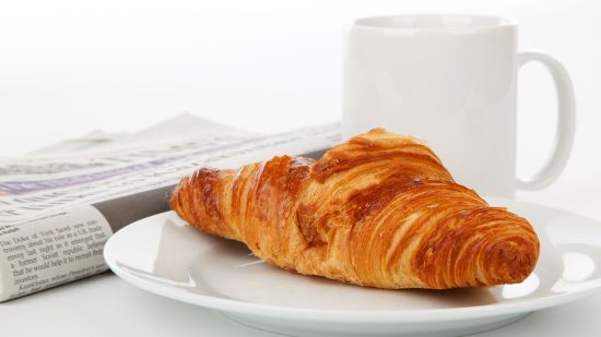 a croissant and a cup of coffee
