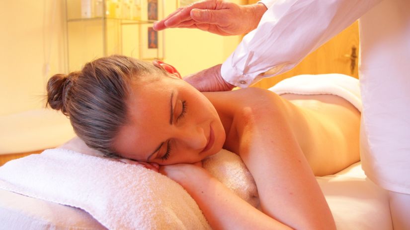 a masseuse massaging a woman at a wellness spa