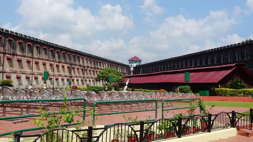 the exterior facade of cellular jail in Port Blair with white clouds on blue sky in the background