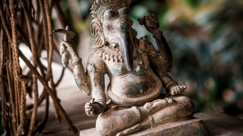 mud idol of lord ganesha placed near a tree