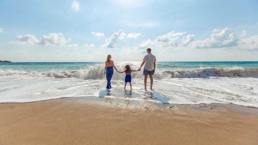 Family standing by the beach shore