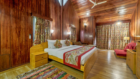 Inside view of the Andaman Cottages (Garden Facing) room featuring a cosy bed and sofa in the corner at Silver Sand Beach Resort, Havelock.