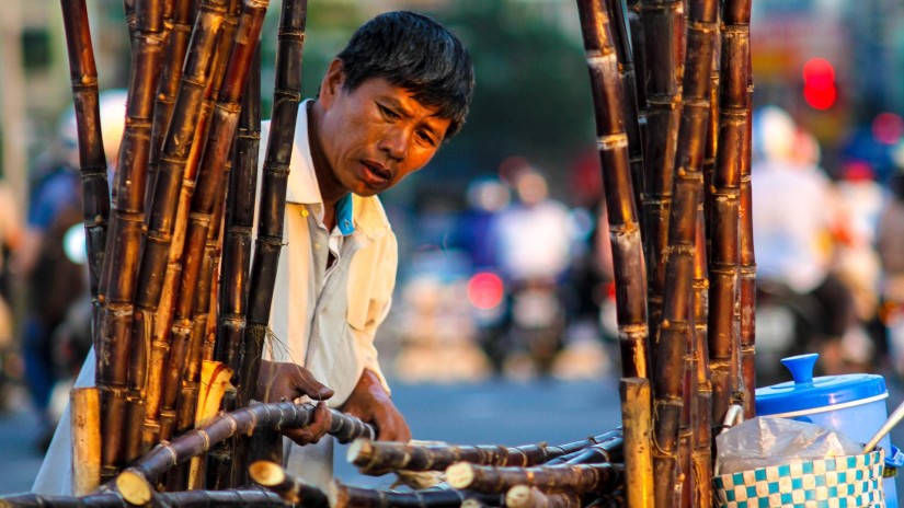 person selling sugarcane juice