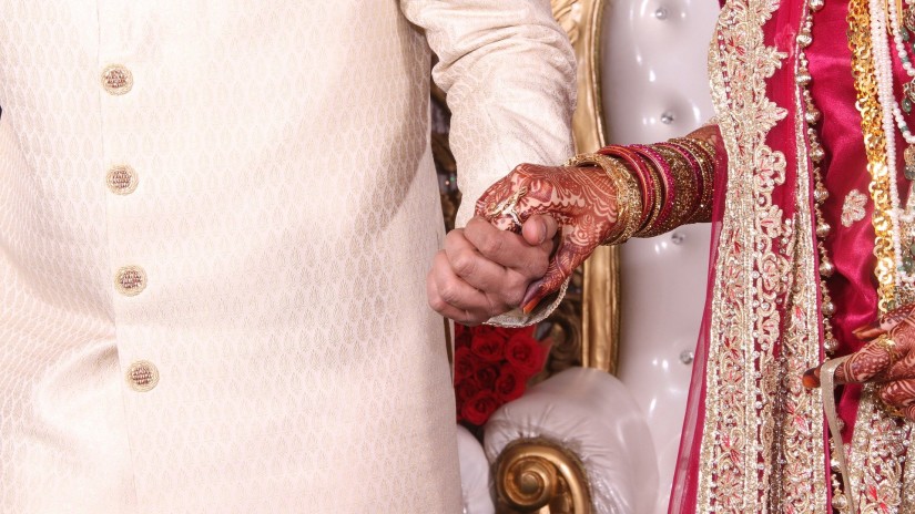 a newlywed couple holding hands