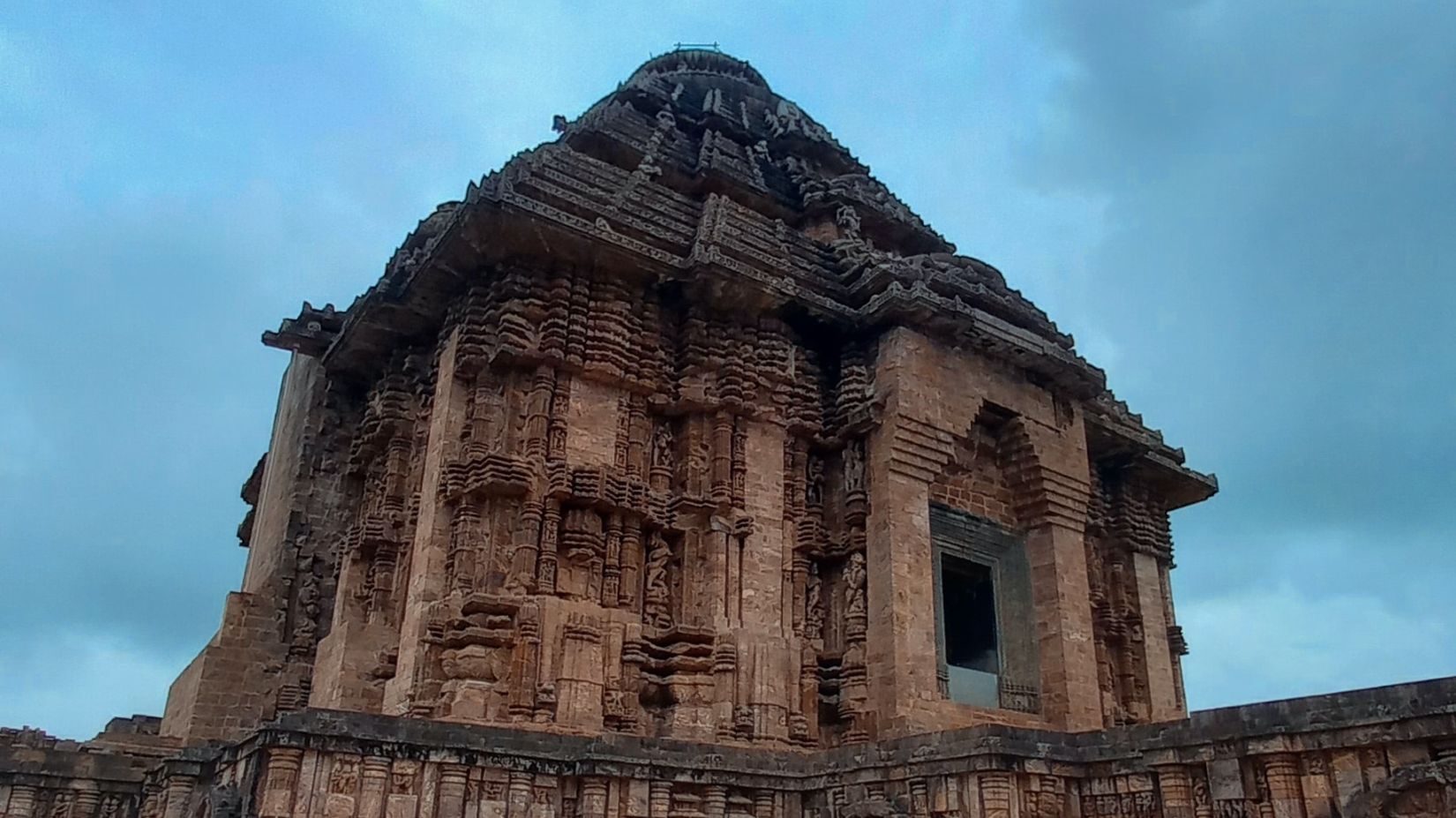 A low angle shot of a stone carved ancient  temple