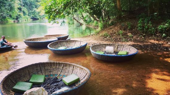 many coracles on the riverbed with forest cover in the background - Black Thunder, Coimbatore