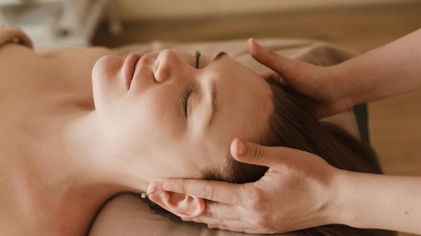 a person laying down with head on a pillow to do sleep massage for head