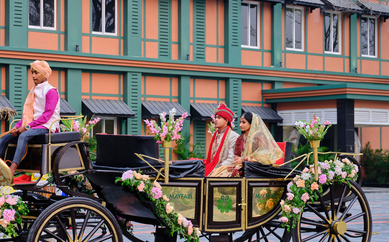 a carriage being driven on which a newly married couple sits - Mayfair Tea Resort, Siliguri 2