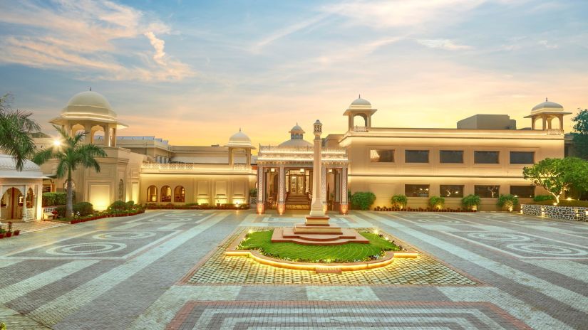 an overview of the Facade of Heritage Village Resorts & Spa, Manesar with the evening sky in the background