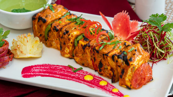 A plate of food kept on a table - The Orchid Hotel, Jamnagar