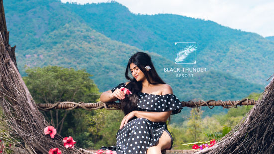 a girl posing for a picture in a structure symbolising love - Black Thunder, Coimbatore