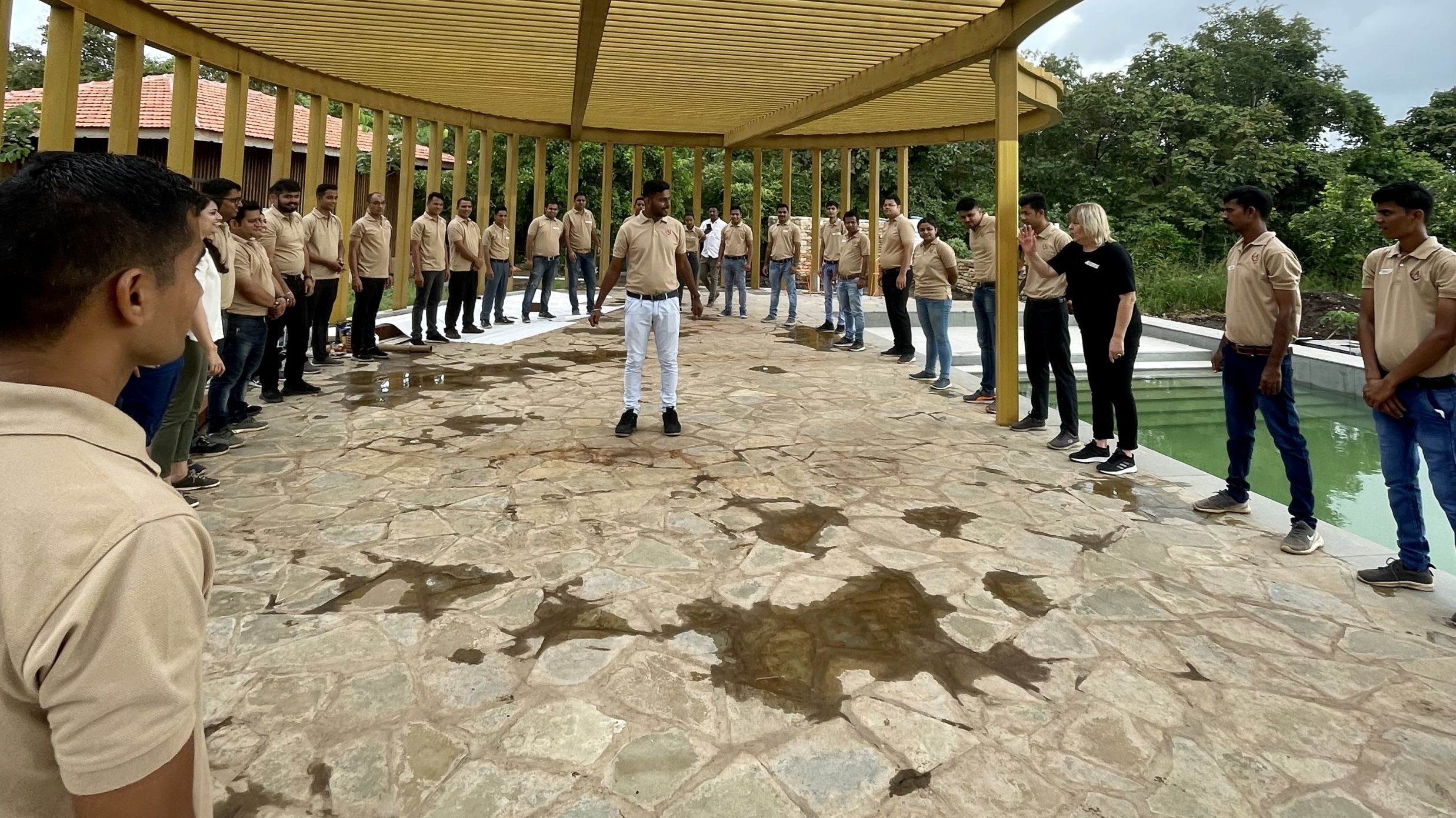 Group of people getting trained near a pool