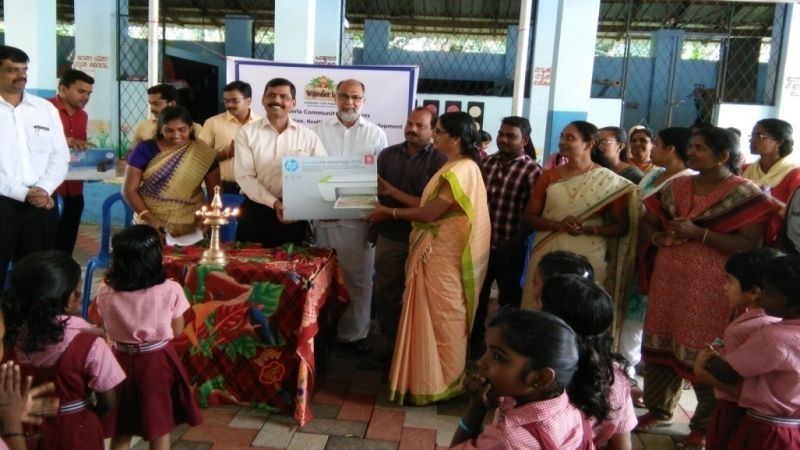 Gifting a printer to the teachers with children as audience