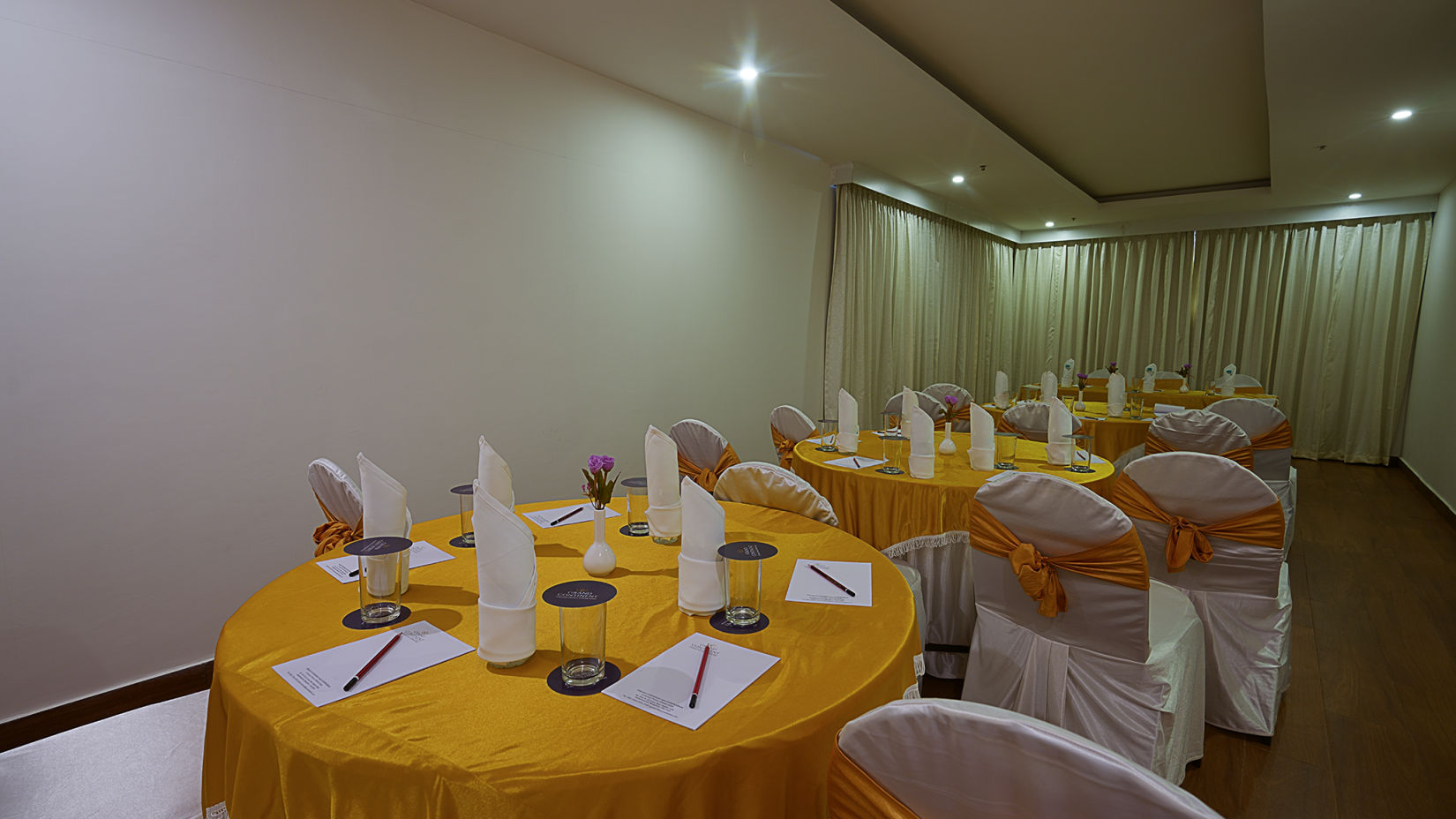 Another view of round tables with comfortable chairs pointed towards the speaker - Grand Continent, Malleshwaram