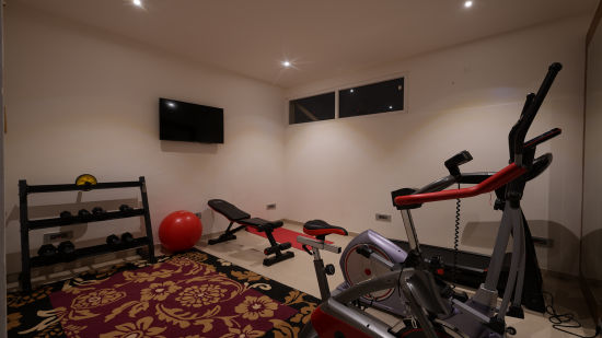 A fitness centre at our hotel with equipment like thread mill and dumbbells - Grand Continent, Malleshwaram