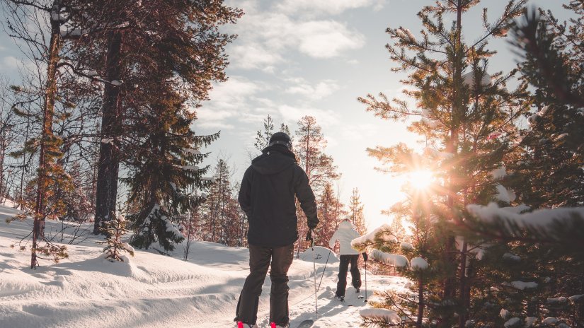 people walking on thick layer of snow with ski equipment learning certified skiing in Auli