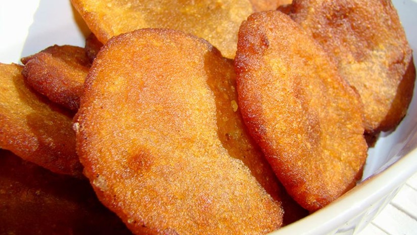 Golden fried snack slices in a bowl, typical food from Coorg