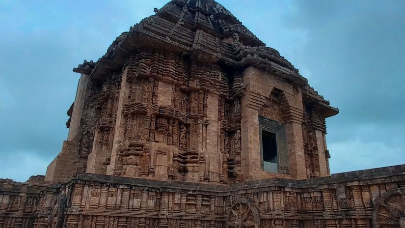 view of the exterior facade of Konark Sun Temple in the evening