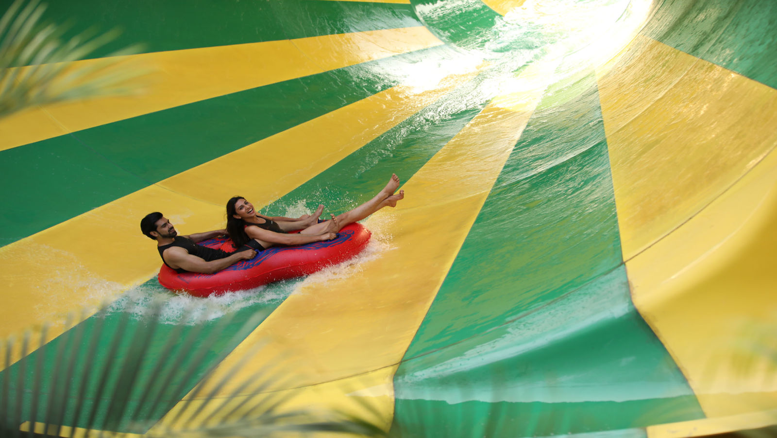 Man and woman going down a spiral water slide