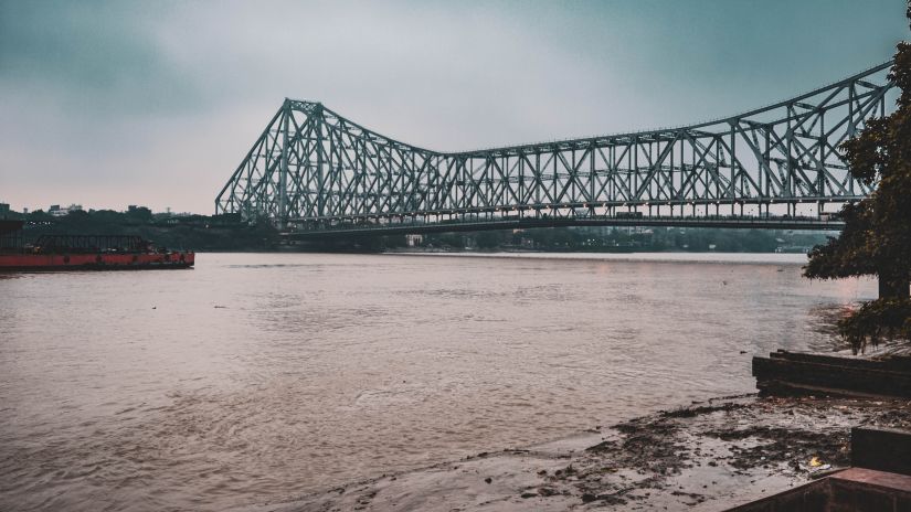 view of howrah bridge and river hooghly flowing under it