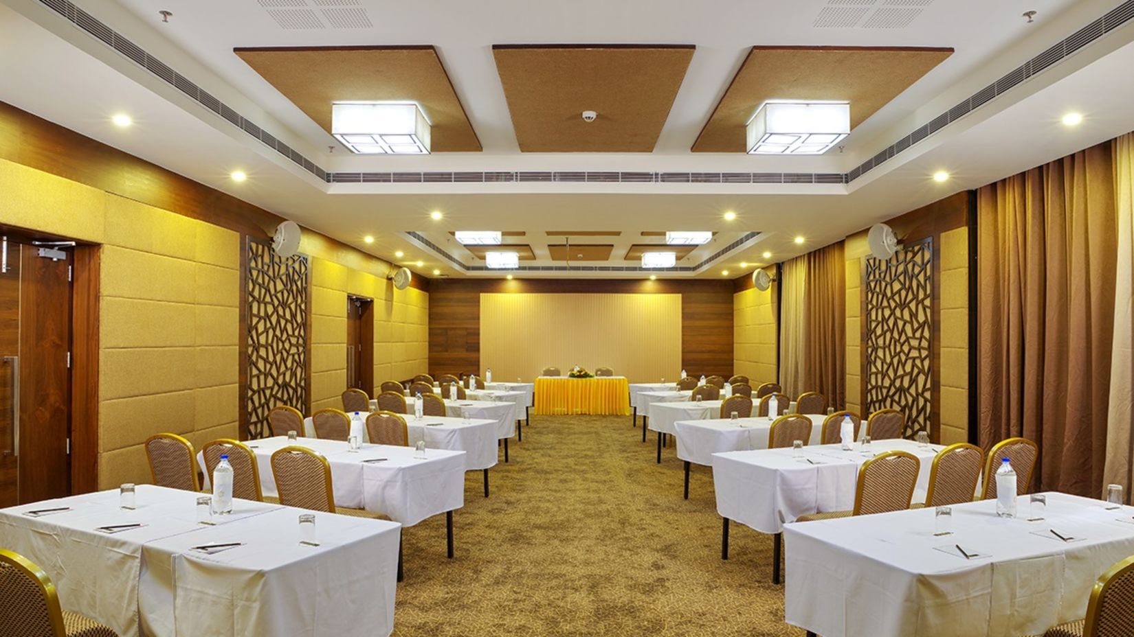 Dimora Thiruvananthapuram - image of Sapphire conference hall featuring brown and beige interiors with numerous seating options
