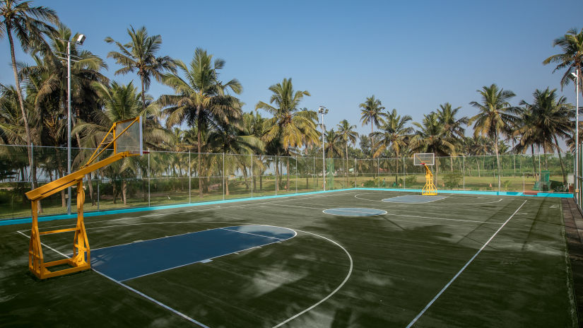 A view of the Basketball Court  with coconut trees covering the sides - Kenilworth Resort and Spa, goa