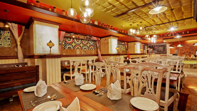 Dining tables with chairs at the spice at Hablis Hotel, Chennai