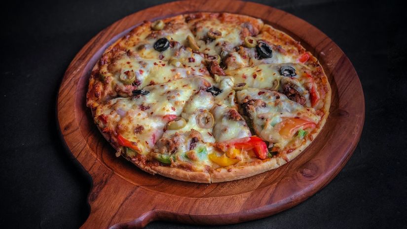 a pizza on a wooden peel