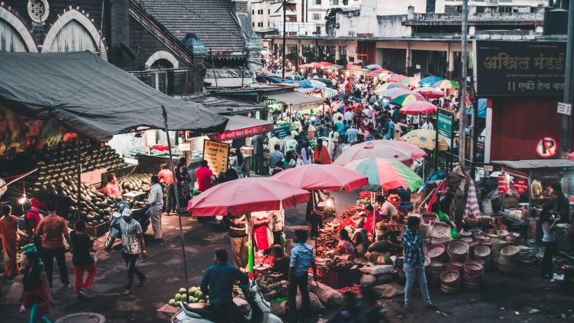 a busy market with many stalls opened side by side